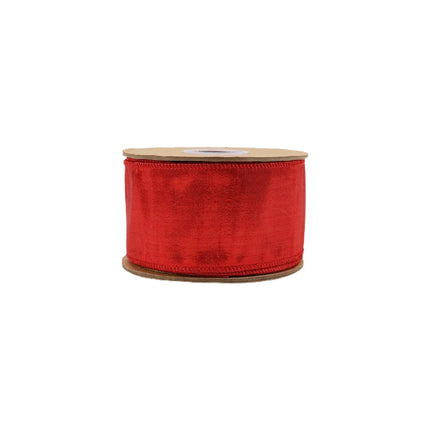 The spool of ornamental ribbon with a smooth, vibrant red fabric that has a metallic glow.