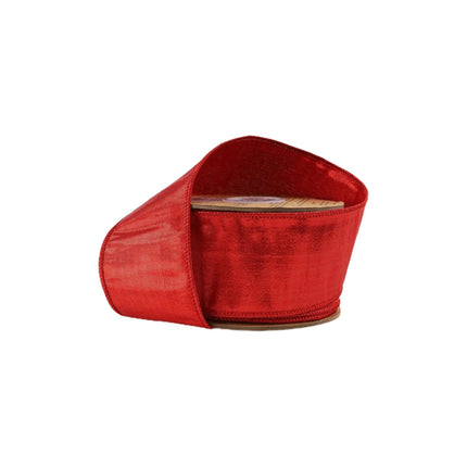 A spool of vibrant red ribbon with a shiny, textured finish,  glossy appearance, ideal for festive uses.
