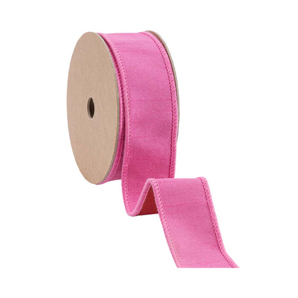 A roll of textured pink ribbon with a red backing, great for creating girly accents and decorative elements.