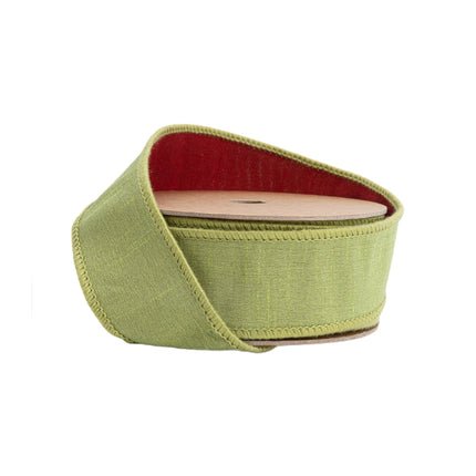 A spool of green Double-fused Dupioni wired ribbon with a red reverse side, ideal for rustic decor and seasonal projects.