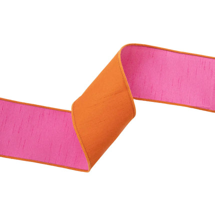 Textured orange double-sided dupioni ribbon lined with hot pink, perfect for birthday gift wrapping