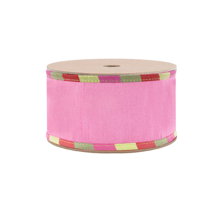 A spool of reversible pink textured ribbon with green, red, and pink plaid edges and a green reverse, ideal for crafting with a colorful, stylish aesthetic.