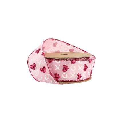 Pink wired ribbon spool (partially unrolled): red glitter hearts, white XO, red trimmed edges.