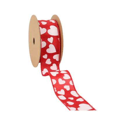 Red wired ribbon spool; multi-size white hearts, partial unroll.