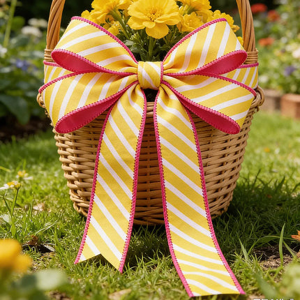 Bright yellow-white diagonal stripe wired ribbon bow with pink backing, decorating a wicker flower basket 