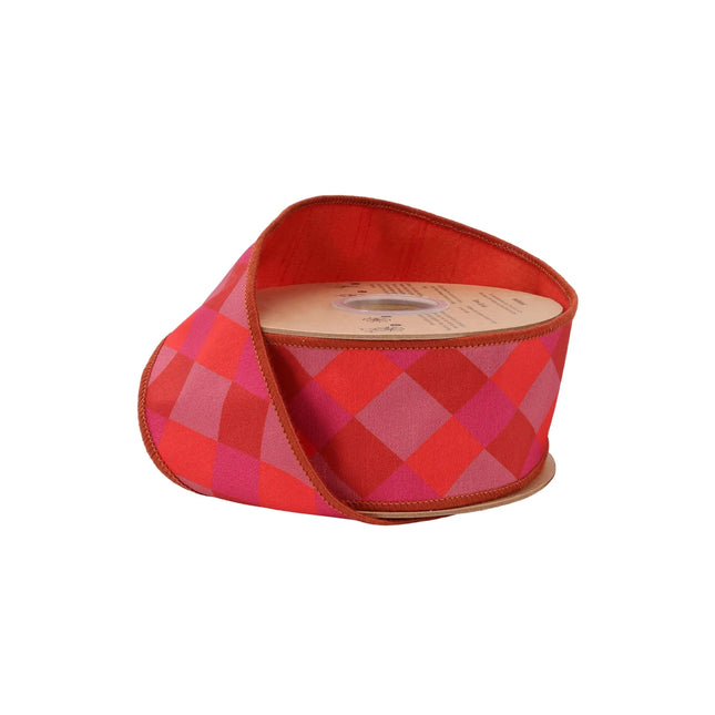 2 1/2" wired dupioni ribbon with orange, pink, red bias plaid and red fused dupioni backing, ideal for gift wrapping.