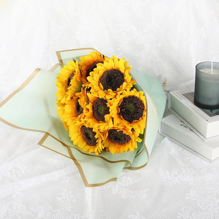 Bright sunflower bouquet wrapped in sage matte floral sheets with gold edge, perfect for gifting 