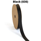 Black textured grosgrain ribbon on spool, partially unrolled