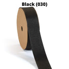 Black textured grosgrain ribbon on spool, partially unrolled