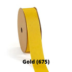 Spool of gold grosgrain ribbon, unrolled to display its textured weave.