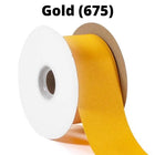 Spool of gold grosgrain ribbon, unrolled to display its textured weave.