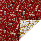Reversible metallic Christmas wrapping paper with red nutcracker & holly print front and gold holly scroll reverse
