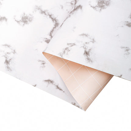 Folded white marble wrapping paper: smooth, neat for sophisticated presents.