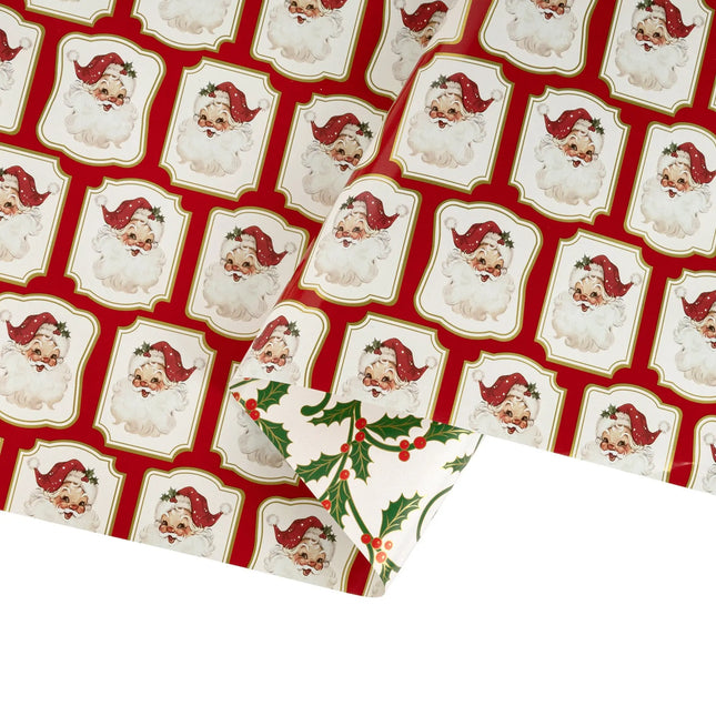 Double-sided metallic gift wrap featuring retro Santa plaque print front and classic green red holly scroll pattern back
