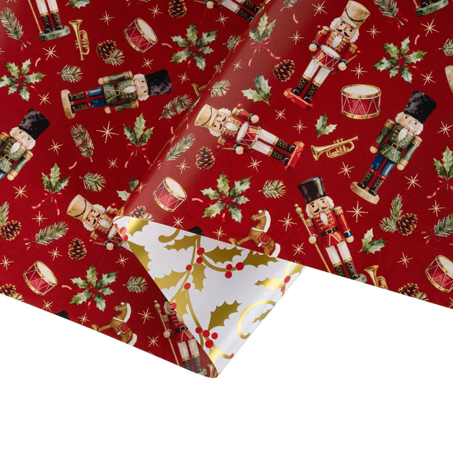 Double-sided holiday gift wrap featuring vintage nutcracker toy pattern and shiny metallic gold holly scroll artwork