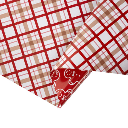 Double-sided festive gift wrap featuring soft brown-red plaid and playful white gingerbread outline pattern