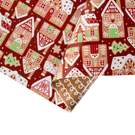 Double-sided festive gift wrap featuring cozy gingerbread village print and simple white icing swirls