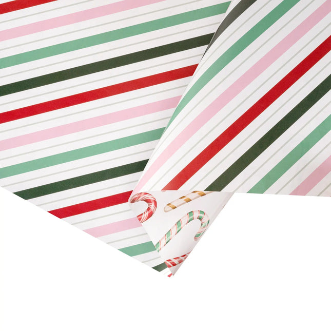 Double-sided festive gift wrap featuring pink-red-green diagonal stripe and playful candy cane pattern