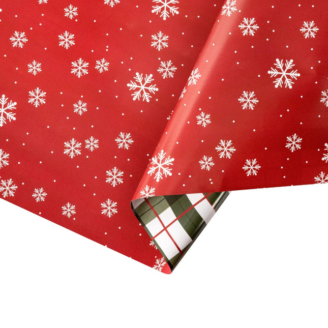 Double-sided gift wrap featuring bright red snowflake pattern and cozy green-red plaid