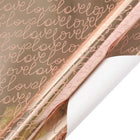 Rose gold metallic wrapping paper with script “love” (white back); gift wrapping.