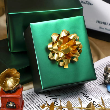 Matte green wrapped gift boxes with gold bow, perfect for holiday, birthday and upscale gift presentation.