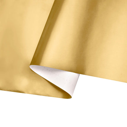 Folded gold wrapping paper: durable, grid-back for neat festive gift wrapping.
