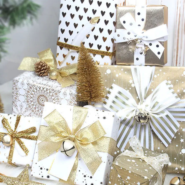 Luxury holiday gift set with gold and white wrapped presents, satin bows, jingle bells