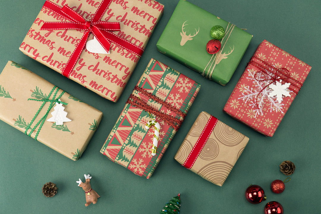 Collection of green and red kraft gift boxes, wrapped with red gift bows